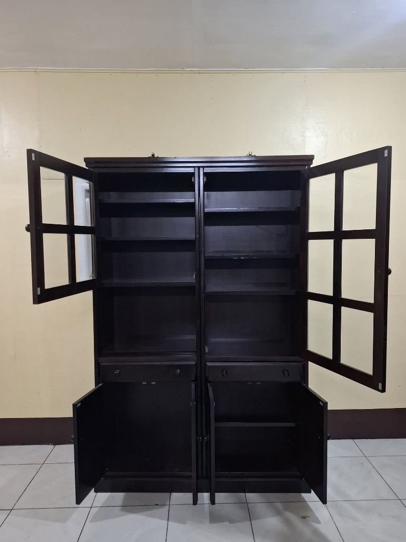 Display Hutch Storage Cabinet Platera Bookcase (Category: Shelves, Cabinets & Racks) located in Quezon City. Submitted by dannikkishoppe2 (Listing ID 1465385085, Image 2). Description: Display Hutch Storage Cabinet Platera Bookcase‼️₱11000‼️ • Finish: Deep brown with visible wood joinery • Dimensions: 46.5"L x 14.5"W x 70.75"H • Upper Section: Glass-paneled doors with interior shelves for display • Middle Section: Two functional pull-out drawers 