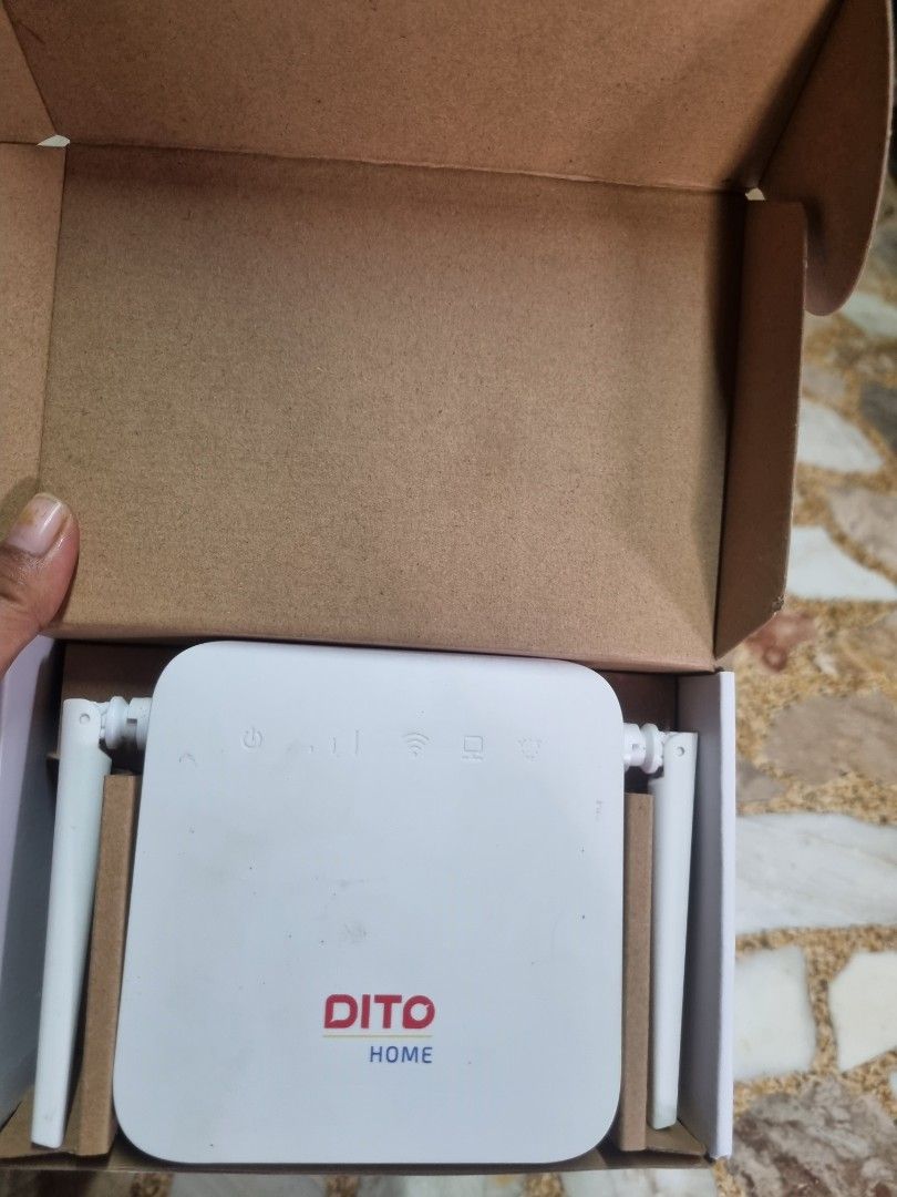 Dito Home 4G Modem Wireless Router (Category: Networking) located in Manila. Submitted by monya111 (Listing ID 1465400468, Image 1). Description: - Brand new, unused Dito Home wireless router - Sleek white casing with dual external antennas - Status indicator icons and official Dito logo on the front - Comes complete in the original brown cardboard box - Includes a branded Dito carrier paper bag - Stored safely inside protective paper inserts.