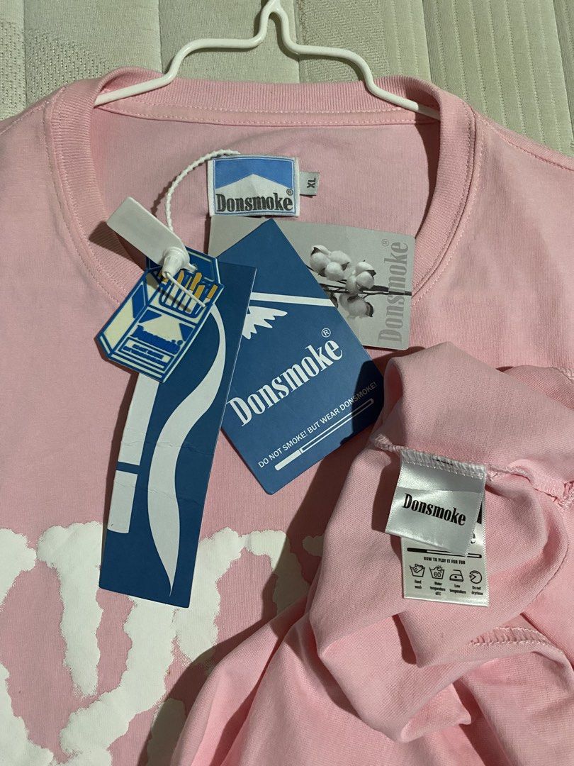 Donsmoke graphic t-shirt (Category: Tshirts & Polo Shirts ) located in Cebu City. Submitted by patspickph (Listing ID 1465417536, Image 3). Description: This is a pink Donsmoke graphic t-shirt featuring an "I Don't Smoke" puffy foam print logo on the chest. Brand New with tags Excellent Condition👍👌size XL on tag W25 L32.