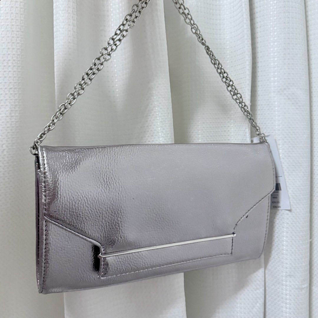 Dorothy Perkins Silver Metallic Envelope Clutch Bag (Category: Luxury Bags & Wallets) located in Valenzuela. Submitted by refined.finds (Listing ID 1465551321, Image 2). Description: Please READ including Mailing & Delivery ‼️ Dorothy Perkins Metallic Evening Clutch / Sling Bag Condition: Unused Dorothy Perkins evening clutch with original tag still attached. Features a metallic silver finish with sleek metal detailing — perfect for weddings, par