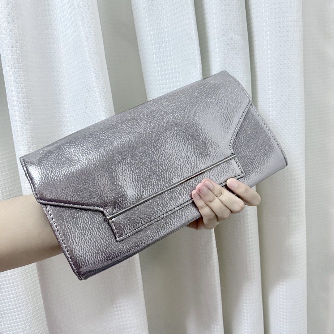 Dorothy Perkins Silver Metallic Envelope Clutch Bag (Category: Luxury Bags & Wallets) located in Valenzuela. Submitted by refined.finds (Listing ID 1465551321, Image 1). Description: Please READ including Mailing & Delivery ‼️ Dorothy Perkins Metallic Evening Clutch / Sling Bag Condition: Unused Dorothy Perkins evening clutch with original tag still attached. Features a metallic silver finish with sleek metal detailing — perfect for weddings, par