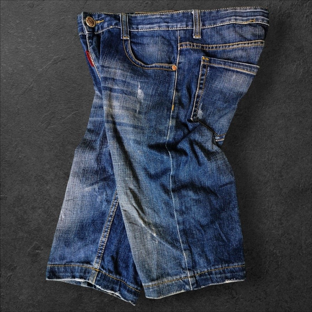 Dsquared2 Denim Shorts Boys Size (Category: Shorts) located in Manila. Submitted by gerald_quinto (Listing ID 1465479266, Image 1). Description: - Brand: Dsquared2 -Size 30 -Length 23 -Hem 8 - Style: Denim shorts with mid-length cut and frayed raw hem - Color/Wash: Medium blue wash with contrast yellow stitching - Details: Embroidered flag patches on the front, red label accent, and branded metallic buttons - Pockets: Two back patch pockets with 