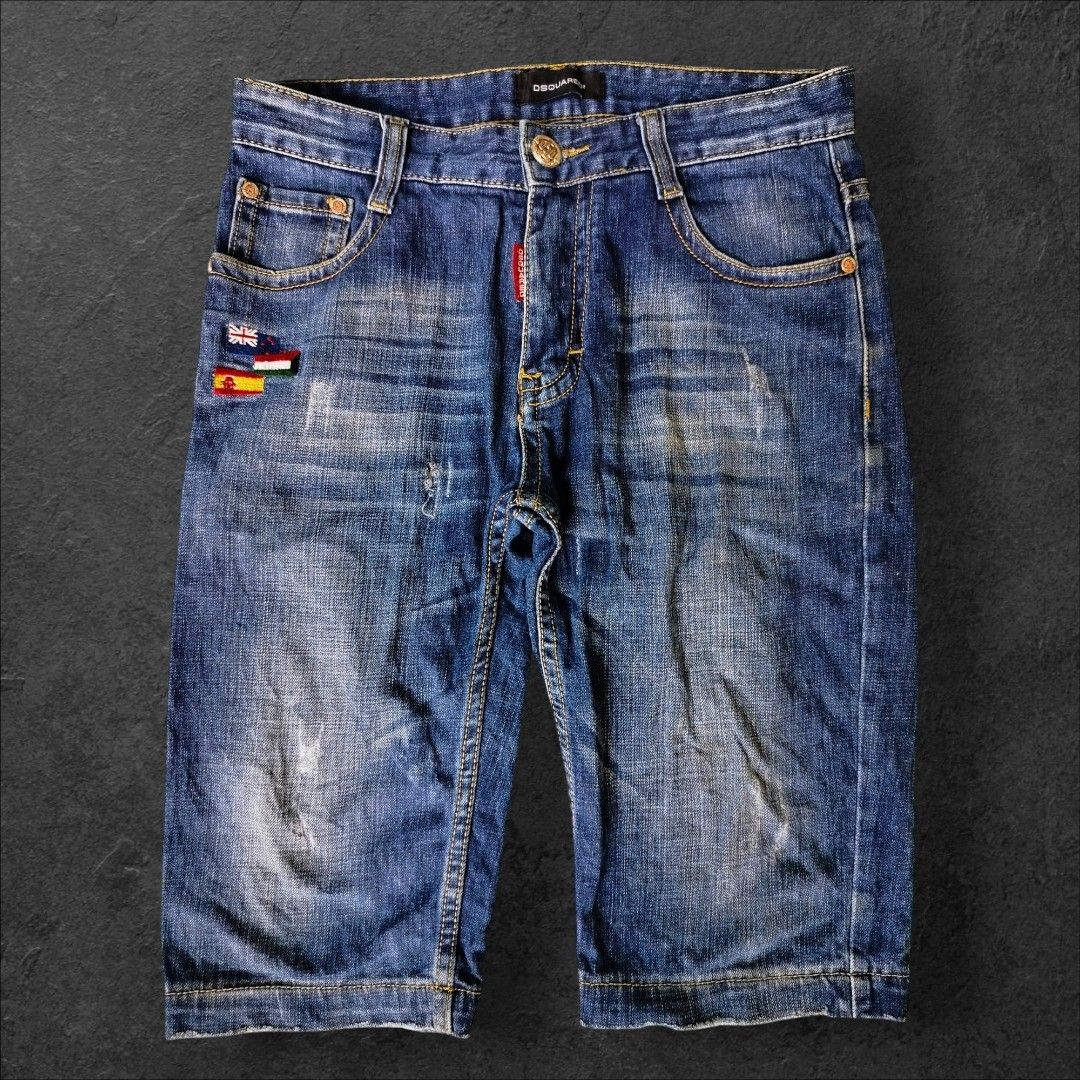Dsquared2 Denim Shorts Boys Size (Category: Shorts) located in Manila. Submitted by gerald_quinto (Listing ID 1465479266, Image 2). Description: - Brand: Dsquared2 -Size 30 -Length 23 -Hem 8 - Style: Denim shorts with mid-length cut and frayed raw hem - Color/Wash: Medium blue wash with contrast yellow stitching - Details: Embroidered flag patches on the front, red label accent, and branded metallic buttons - Pockets: Two back patch pockets with 