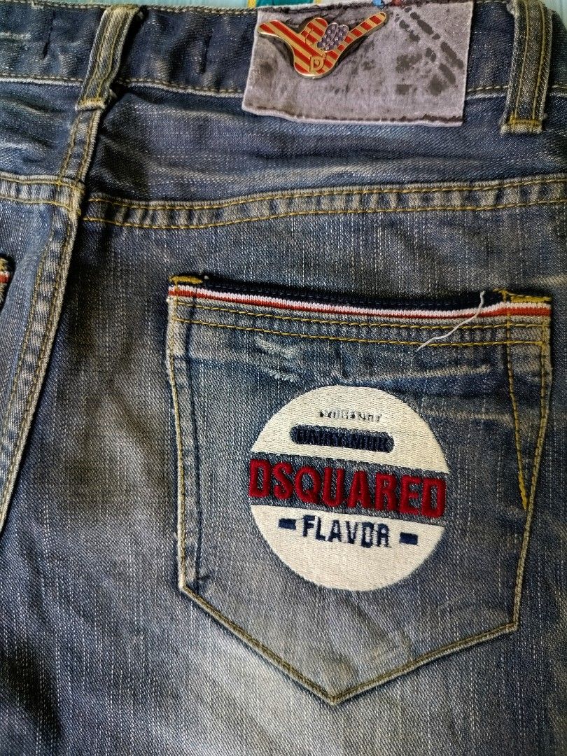 Dsquared2 Flavor Distressed Denim Jeans (Category: Jeans) located in Manila. Submitted by gerald_quinto (Listing ID 1465476701, Image 3). Description: - Brand: Dsquared2 -Size 28-29 -Length 39 -Hem 7 - Style: Vintage-wash straight leg jeans with heavy distressing and whiskering - Pockets: Classic 5-pocket styling with unique angled front pockets and contrast red and white stitching - Details: Branded leather back patch and large round embroidered