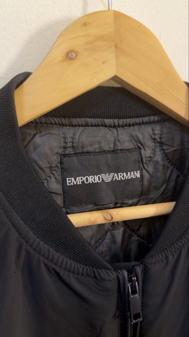 EA7 Emporio Armani Black Bomber Jacket (Category: Coats, Jackets and Outerwear) located in Paranaque City. Submitted by preluxeshop_ph (Listing ID 1465549463, Image 3). Description: EA7 Emporio Armani Black Bomber Jacket - Color: Black with white branding - Style: Bomber jacket with full zip front - Details: White EA7 logo on chest, large embroidered MILANO text on back shoulders - Interior: Quilted inner lining with branded neck tag - Fit/Feel: 