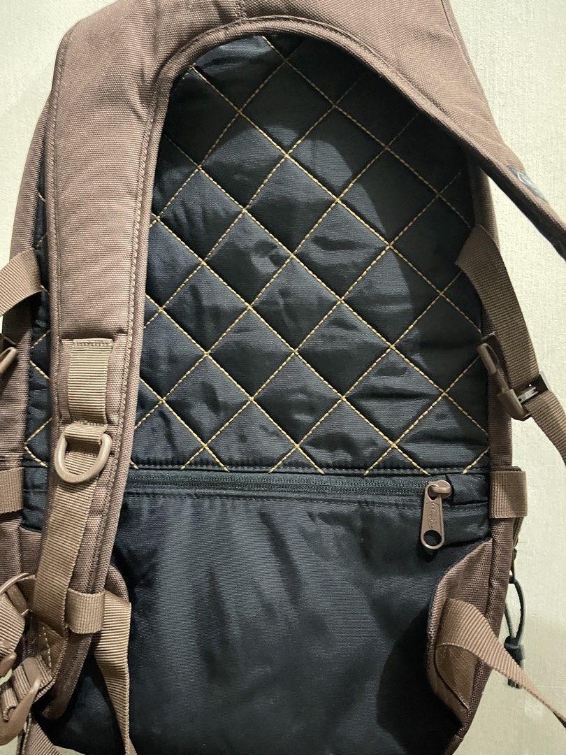 Eastpak Brown Backpack with Quilted Back (Category: Backpacks) located in Quezon City. Submitted by akismurabels (Listing ID 1465480540, Image 3). Description: PRELOVED/DECLUTTERING PERSONAL ITEMS MOP: Gcash MOD:Lalamove Loc:Visayas ave.Quezon City SIZE: L:30cm H:45cm W:9cm - Authentic brown Eastpak backpack with secure front buckle straps - Quilted black back panel featuring stylish contrast yellow stitching - Large main compartment equipped wit