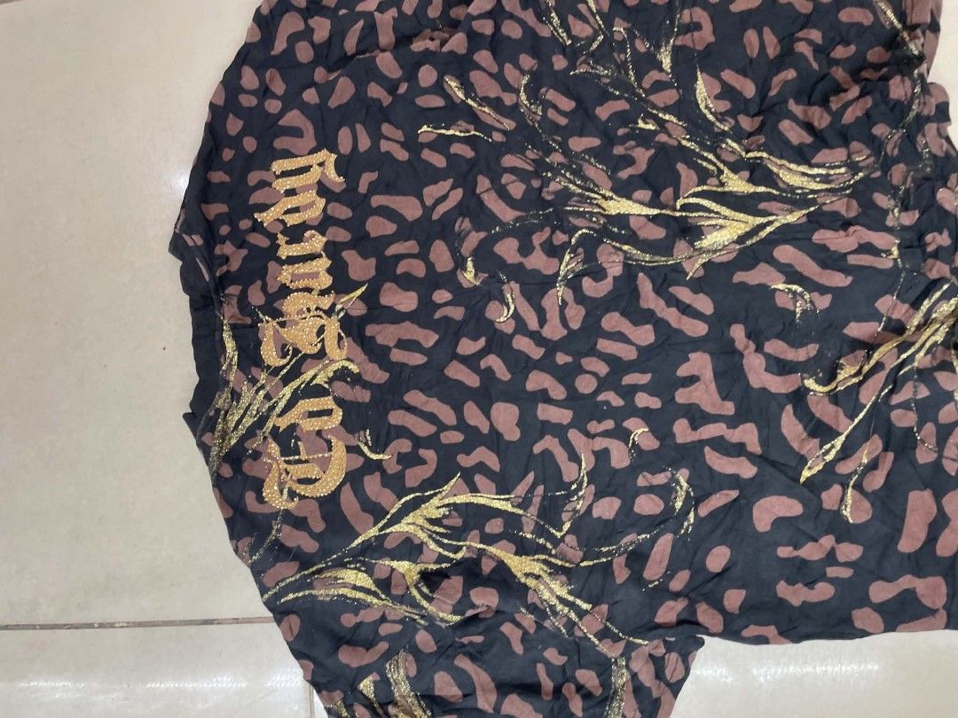 Ed Hardy Leopard Panther Graphic Tee Short Sleeve (Category: Tshirts & Polo Shirts ) located in Cainta. Submitted by riszizlux (Listing ID 1465472094, Image 2). Description: - Authentic Ed Hardy graphic t-shirt with gold neck tag - Bold all-over leopard print with glitter detailing - Large front panther graphic with gold embroidered text overlay - Relaxed crew neckline and short sleeves - Trendy oversized fit.