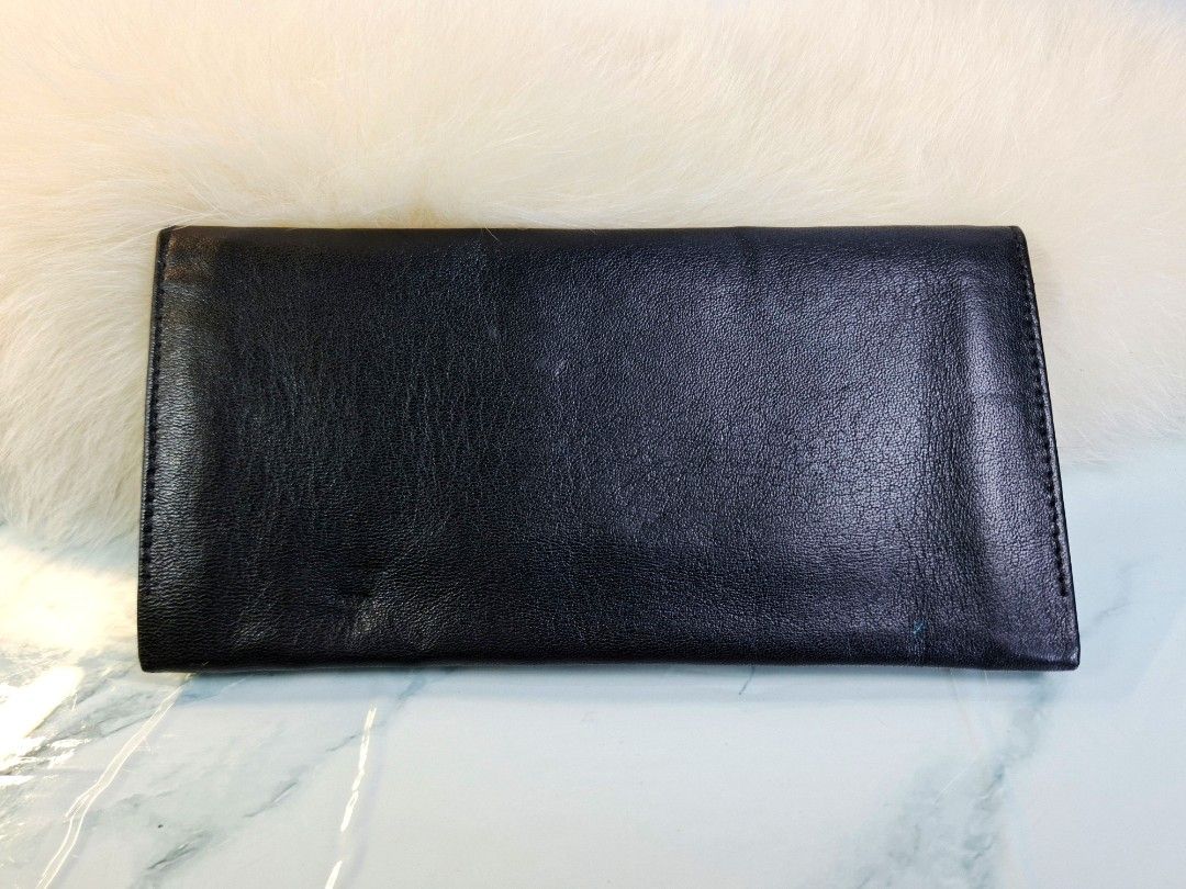 Emanuel Ungaro Black Leather Long Wallet (Category: Wallets & Card holders) located in Pasay City. Submitted by onick_79 (Listing ID 1465498653, Image 3). Description: - Brand: Emanuel Ungaro Paris - Material: Smooth black leather - Design: Slim fold-over with debossed front logo - Interior: Multiple card slots, cash compartments, and receipt pockets - Style: Minimalist and practical for everyday use - Condition: Excellent.