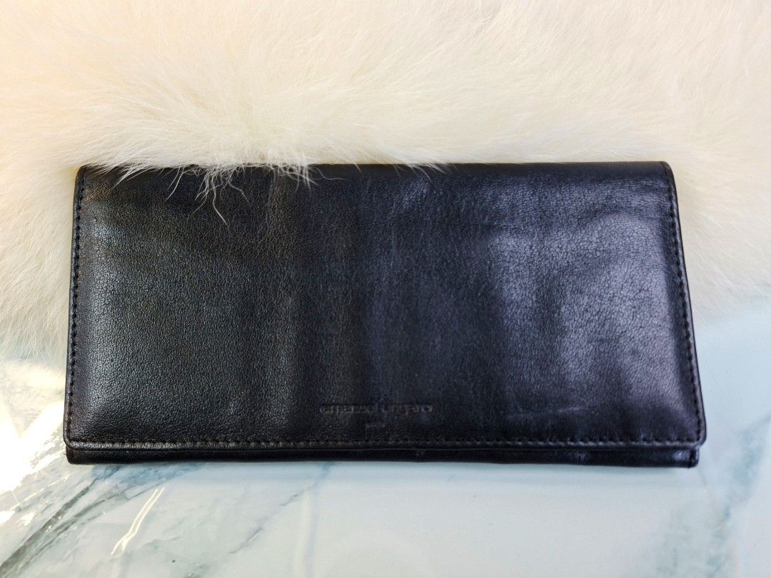 Emanuel Ungaro Black Leather Long Wallet (Category: Wallets & Card holders) located in Pasay City. Submitted by onick_79 (Listing ID 1465498653, Image 2). Description: - Brand: Emanuel Ungaro Paris - Material: Smooth black leather - Design: Slim fold-over with debossed front logo - Interior: Multiple card slots, cash compartments, and receipt pockets - Style: Minimalist and practical for everyday use - Condition: Excellent.