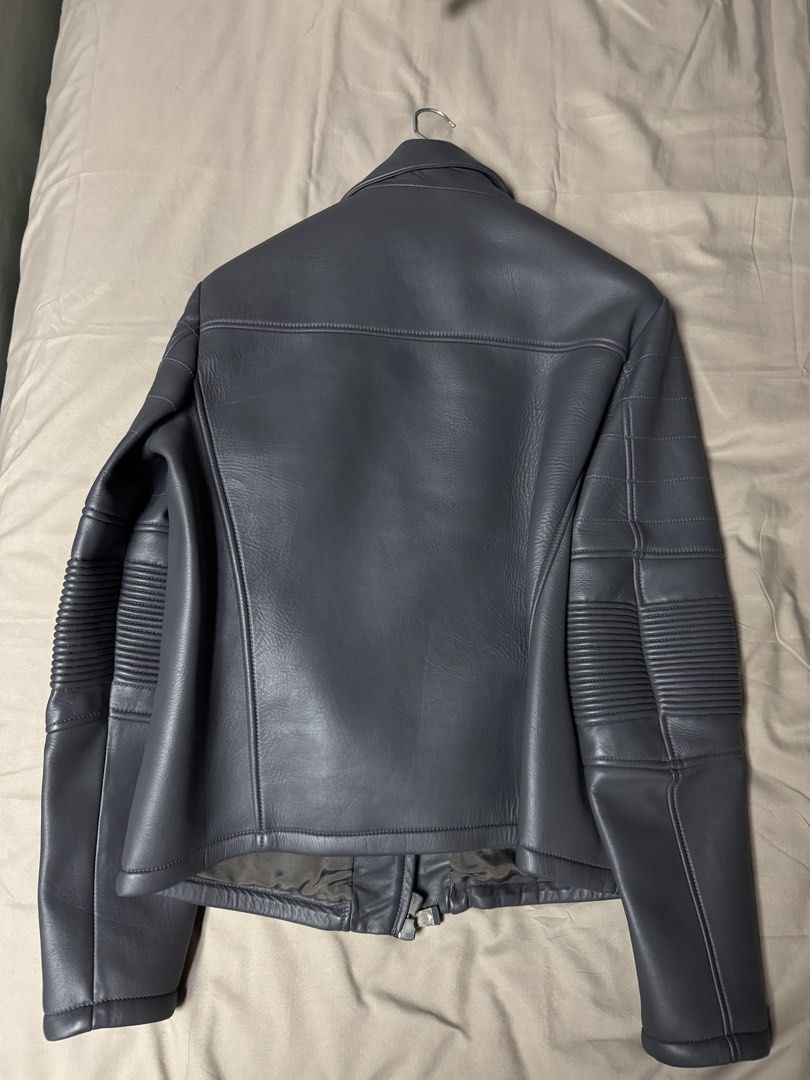 Emporio Armani Grey Leather Biker Jacket (Category: Coats, Jackets and Outerwear) located in Manila. Submitted by seangoart (Listing ID 1465502392, Image 3). Description: - Authentic Emporio Armani leather biker jacket in a versatile grey shade - Edgy asymmetrical front zip closure - Stylish quilted ribbed detailing on sleeves and shoulders - Two lower front zipped welt pockets for daily essentials - Fully lined interior with original brand label