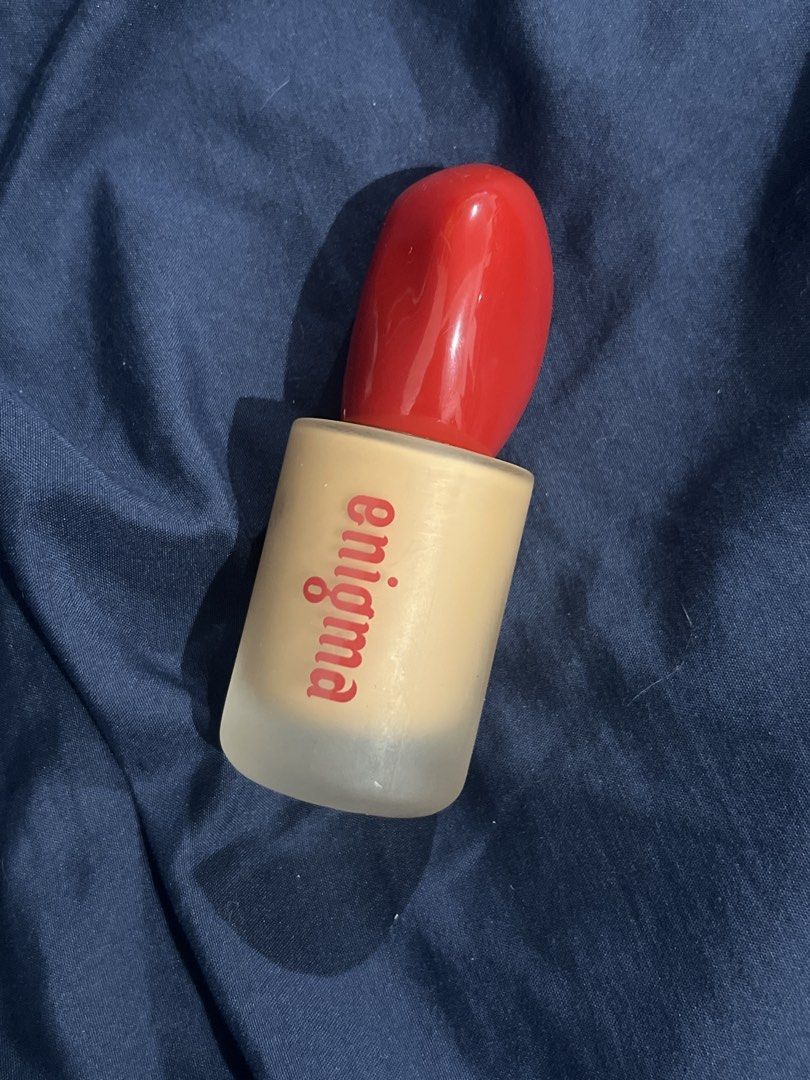 Enigma foundation mw19 honey shade (Category: Makeup) located in Manila. Submitted by vandetoria (Listing ID 1465503420, Image 1). Description: - Product: Enigma Fragrance - Bottle: Frosted glass with matte finish and red lettering - Design: Eye-catching bright red cap shaped like lips - Use: Great as a signature scent, vanity display, or collectible piece - Condition: Brand new and display-ready.