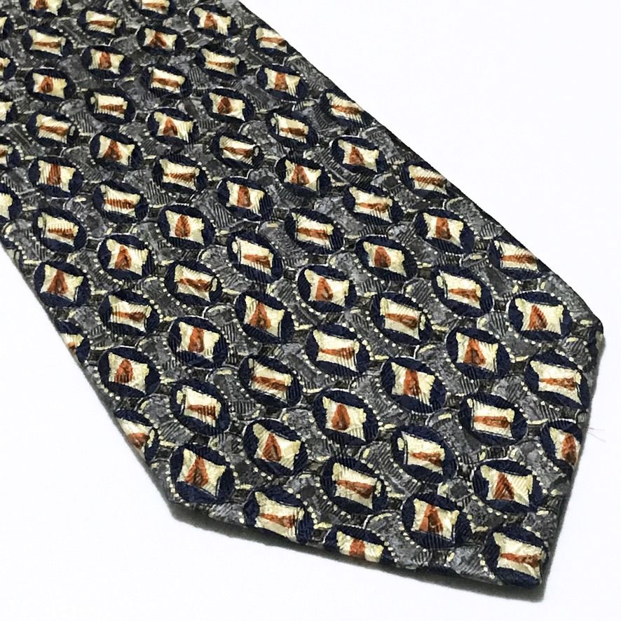 Ermenegildo Zegna Repeating Pattern Deep Navy Neck Tie (Category: Ties) located in Taguig. Submitted by retrogaze (Listing ID 1465421648, Image 2). Description: This vintage 100% silk necktie by Ermenegildo Zegna features a deep navy blue base enriched by a complex, multi-layered jacquard weave. The body displays an intricate repeating geometric grid of dark blue oval motifs set against a textured grey background, each housing a central cream and