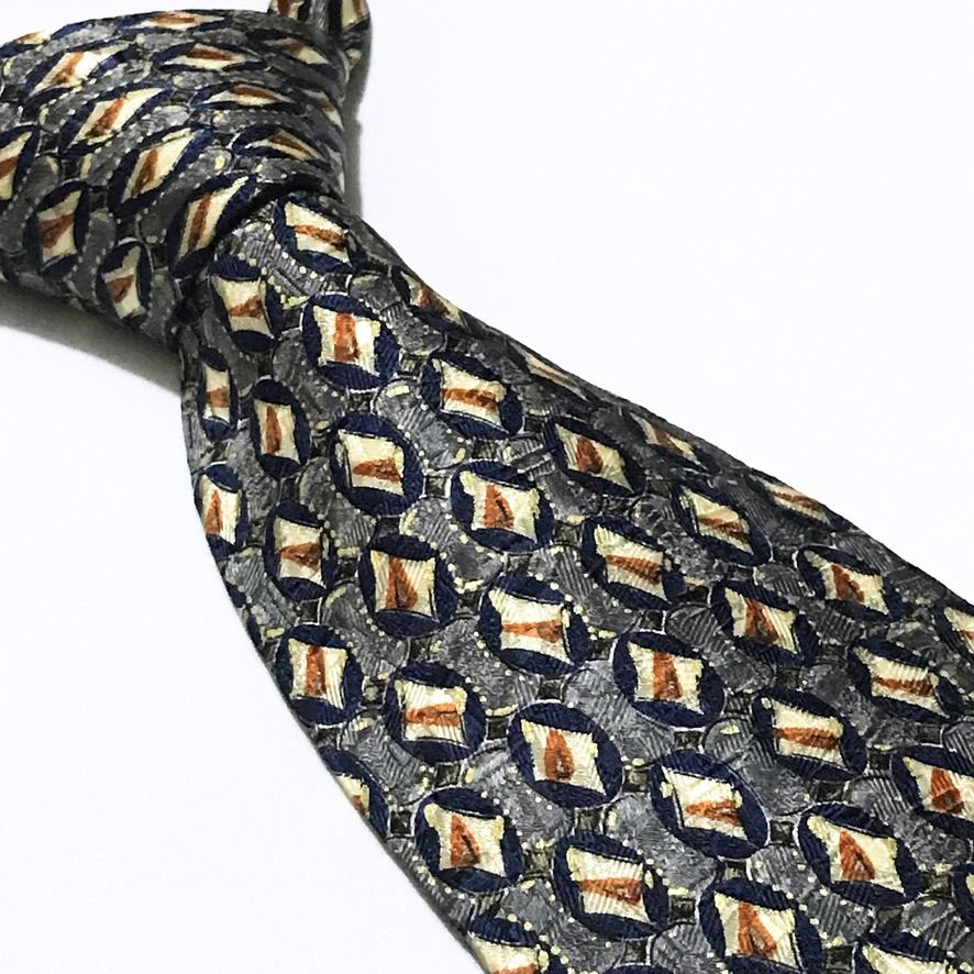 Ermenegildo Zegna Repeating Pattern Deep Navy Neck Tie (Category: Ties) located in Taguig. Submitted by retrogaze (Listing ID 1465421648, Image 1). Description: This vintage 100% silk necktie by Ermenegildo Zegna features a deep navy blue base enriched by a complex, multi-layered jacquard weave. The body displays an intricate repeating geometric grid of dark blue oval motifs set against a textured grey background, each housing a central cream and