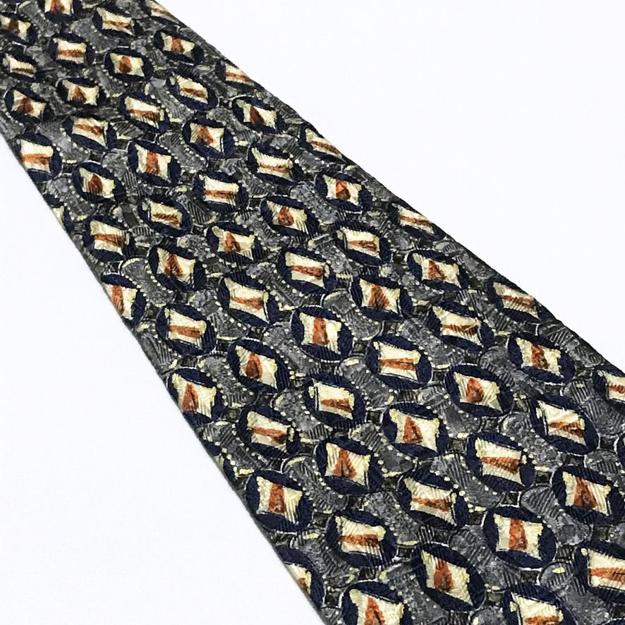 Ermenegildo Zegna Repeating Pattern Deep Navy Neck Tie (Category: Ties) located in Taguig. Submitted by retrogaze (Listing ID 1465421648, Image 3). Description: This vintage 100% silk necktie by Ermenegildo Zegna features a deep navy blue base enriched by a complex, multi-layered jacquard weave. The body displays an intricate repeating geometric grid of dark blue oval motifs set against a textured grey background, each housing a central cream and