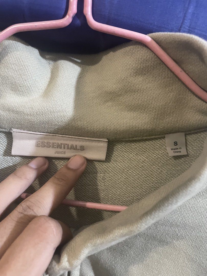 Essentials Juice Full Zip Mock Neck Sweatshirt (Category: Activewear) located in Manila. Submitted by jabjabthriftplace (Listing ID 1465473130, Image 3). Description: - Brand: Essentials Juice - Color: Sage Green - Size: Small (tag attached) - Material: 100% Cotton - Design: Full-zip with mock neck, vertical chest branding, and back collar rubber logo patch - Condition: Brand new with tags.