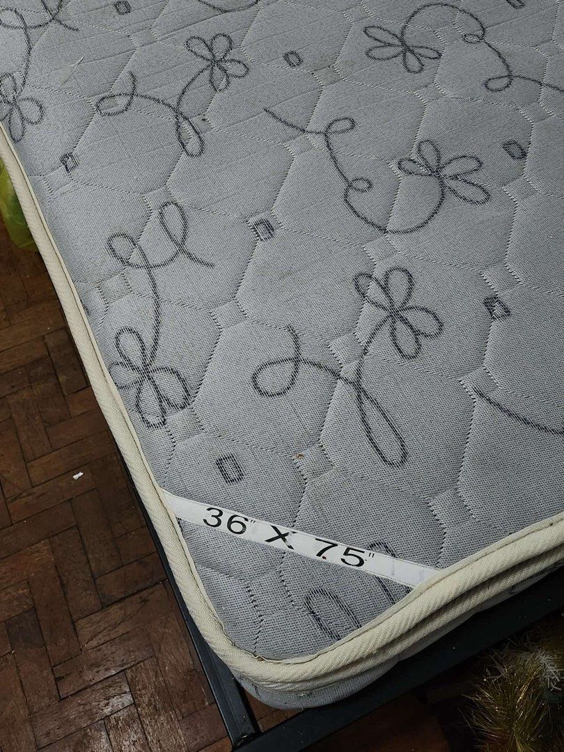 Essentials with padding single mattress 36" x 75" (Category: Bed Frames & Mattresses) located in Taytay. Submitted by arangxx09 (Listing ID 1465419474, Image 2). Description: Single-size essentials mattress (36x75") with a comfortable padded design and grey floral/swirl top. Clean and ready for pickup. Fits standard single bed frames. RFS: Decluttering.