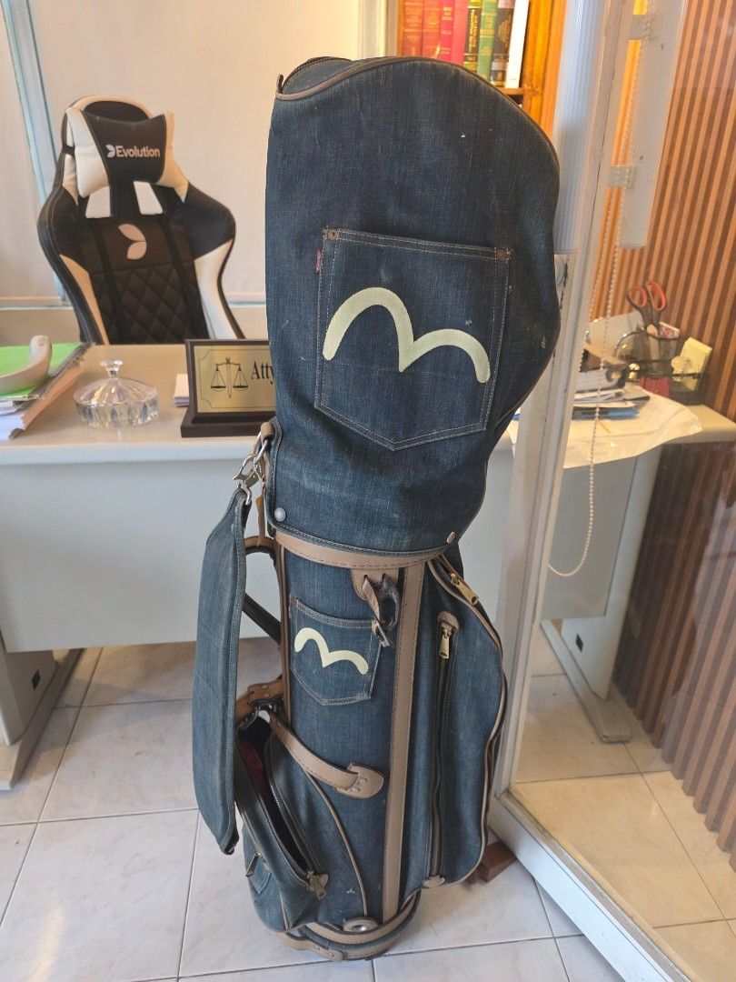 Evisu Denim Golf Bag (Category: Golf) located in Malolos. Submitted by 888collectibles (Listing ID 1465442122, Image 1). Description: - Brand: Evisu - Material: Premium dark blue denim wash with brown leather trim - Design: Iconic painted seagull logo on pockets and classic red tab detail - Storage: Multiple spacious zipper compartments for clubs and gear - Portability: Includes a sturdy carrying strap - Condition: Excellent buyer-friendly piece 