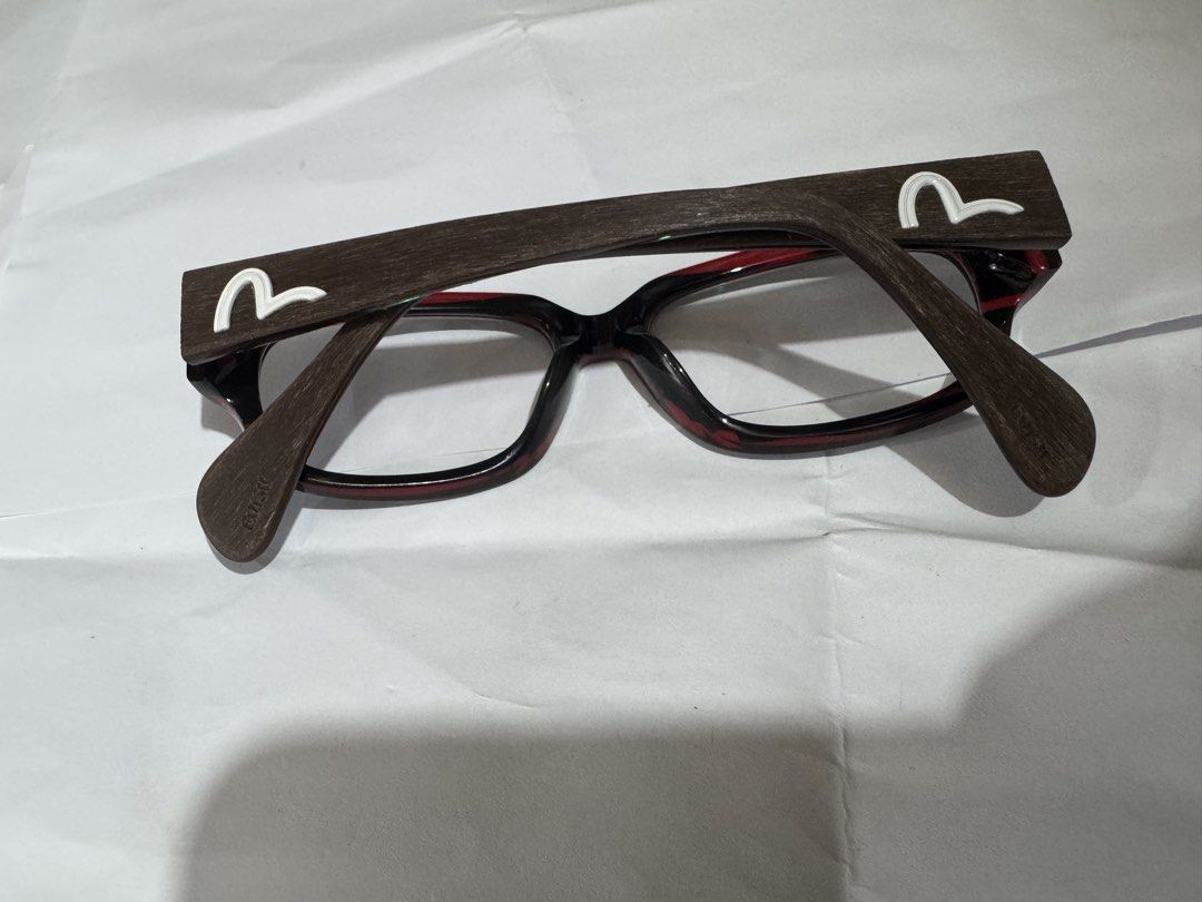 Evisu EVH-8129 Eyeglasse 100% Genuine (Category: Sunglasses & Eyewear) located in Manila. Submitted by wildbear.e10374 (Listing ID 1465422352, Image 1). Description: - Brand: Evisu - Model: EVH-8129 - Colorway: Dark brown and red tortoise shell pattern with signature white seagull logos - Details: Tokyo Osaka branding printed inside the temple arm - Size: 53-16-145 - Hardware: Sturdy metal hinges - Condition: Well-maintained, frame only (ready fo