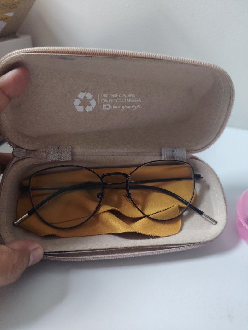 Executive Optical eyewear with cases (Category: Sunglasses & Eyewear) located in Antipolo. Submitted by goodsinger (Listing ID 1465574920, Image 3). Description: - 2 pairs of glasses included: 1 black round frame and 1 red-to-clear gradient plastic frame - Set 1: Comes with a beige EO zip case (70% recycled material) and yellow cleaning cloth - Set 2: Comes with a pink translucent hard case and blue cleaning cloth - Both pairs feature protective 