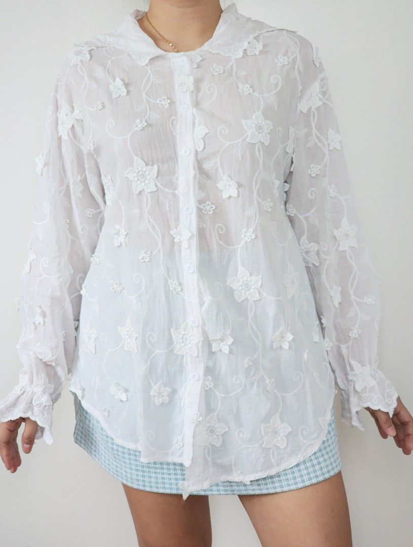 fairycore and whimsy white 3D embroidered shirt (Category: Longsleeves) located in Batangas. Submitted by curatedbylisilaloop (Listing ID 1465430028, Image 2). Description: ❀ fairycore and whimsy ❀ | white 3D embroidered floral sheer hoodie button down with assymetrical hem Size: freesize Bust: 44".