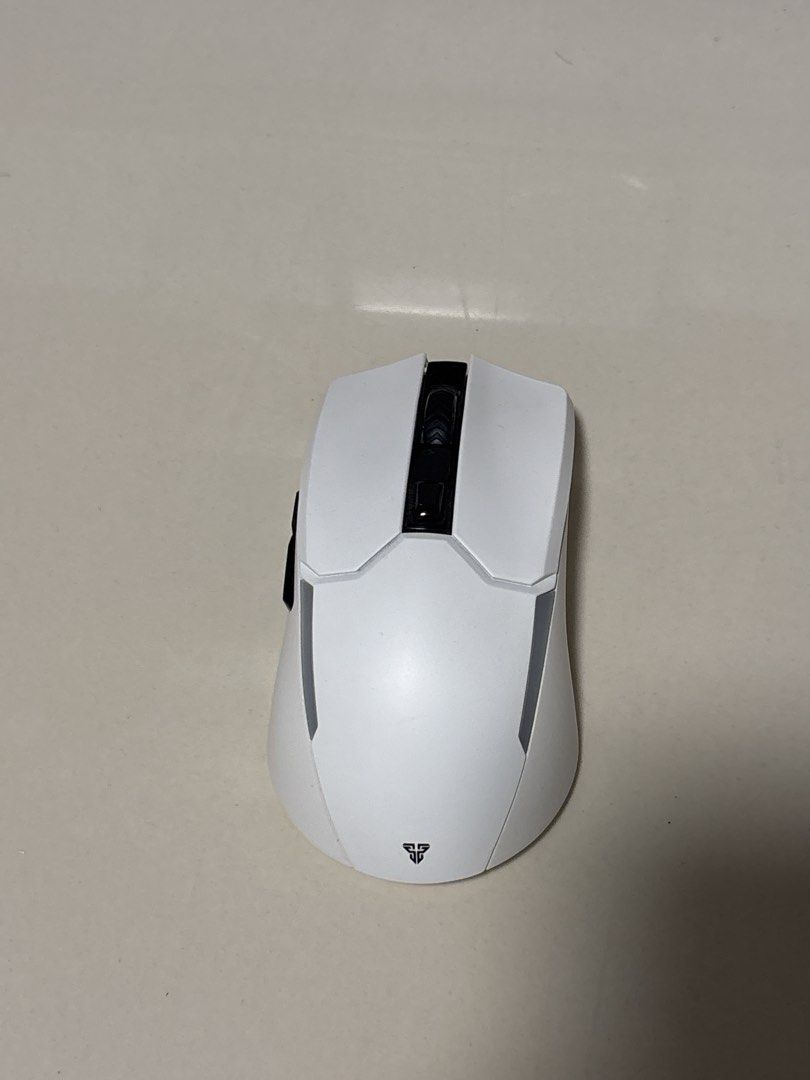 Fantech Venom II WGC2 Wireless Gaming Mouse (Category: Mouse & Mousepads) located in Manila. Submitted by silentdeer.537e56 (Listing ID 1465425174, Image 1). Description: - Model: Fantech Venom II WGC2 Wireless Gaming Mouse - Color: Clean White with black scroll wheel and side buttons - Connectivity: Reliable 2.4GHz wireless - Modes: Dual-mode switch underneath (Eco and On settings) - Performance: Centered optical sensor and smooth glide feet for