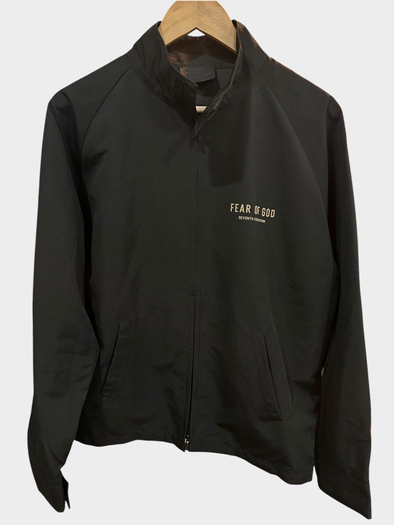 Fear of God Seventh Collection Jacket (Category: Coats, Jackets and Outerwear) located in Bulacan. Submitted by adoseofluxxee (Listing ID 1465482979, Image 1). Description: - Brand: Fear of God (Seventh Collection) - Color: Black nylon with bold cream front and back branding - Features: Zip closure, stand-up collar, and side pockets - Details: Signature rubberized FOG label on the back collar and interior brand tag - Condition: Clean inside and o