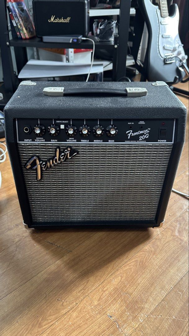 Fender Frontman 20G Guitar Amplifier (Category: Musical Instruments) located in Manila. Submitted by michigoxd (Listing ID 1465401646, Image 1). Description: - Fender Frontman 20G practice amplifier in clean, working order - Dual channels with normal/drive volume, gain control, and 3-band EQ (treble, middle, bass) - Auxiliary input and headphone jack for silent practice - Classic Fender look with black textured vinyl and silver grille cloth - Com