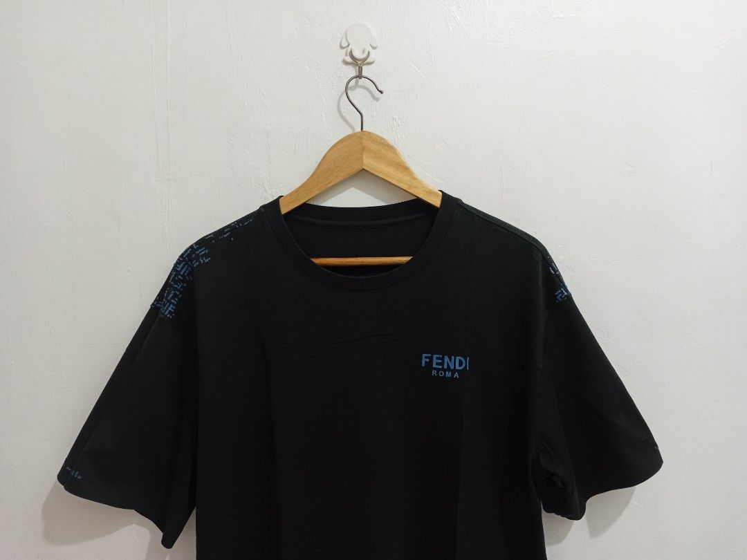 FENDI ROMA MENS TSHIRT (Category: Luxury Apparel) located in Navotas City. Submitted by ms.soulana (Listing ID 1465394807, Image 2). Description: PREOWNED LIGHTLY USED Fendi Roma MENS BLACK TSHIRT - Color: Black with blue logo - Size: Large -XL - Material: 100% cotton - Design: Blue Fendi Roma logo on front chest, repeated down sleeves, and printed on upper back collar - Fit: Standard short sleeve crewneck cut -Likenew ColorRate but have flaws ,o