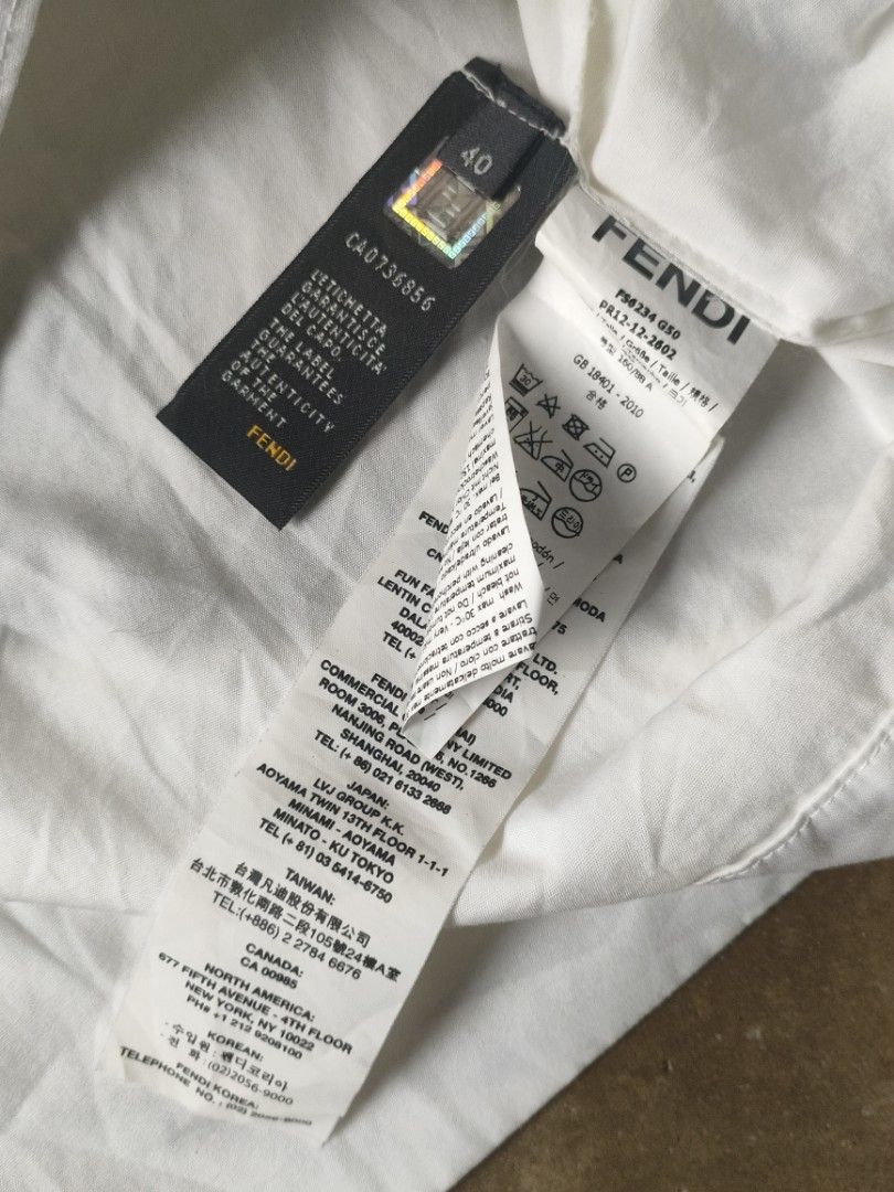 FENDI White Cotton Shirt (Category: Shirts) located in Angeles City. Submitted by thestorageroom (Listing ID 1465459675, Image 3). Description: not totally well used as is where is from japan boxes only needs wash has yellow stains maganda po to pag nalabhan no holes and scratches yung neck tag isa lang talaga nakatahi size 40 on tag offer me for info and dimension negotiable +sf.
