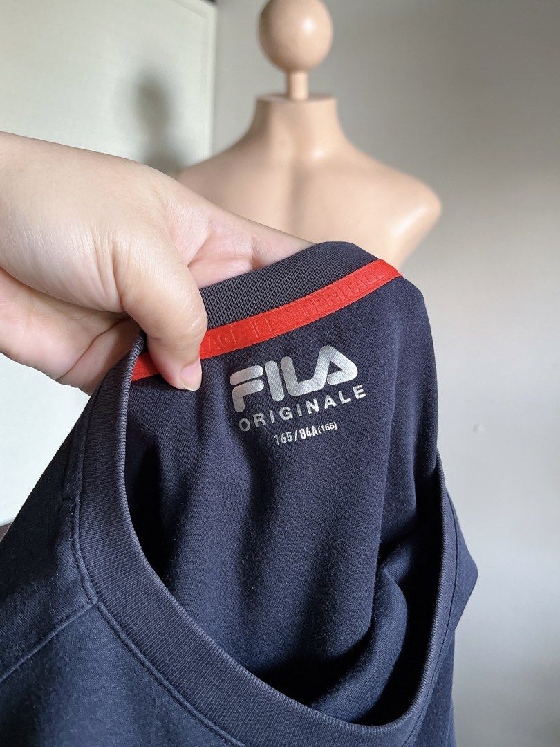 Fila Originale Navy T-Shirt Size Medium (Category: Tshirts & Polo Shirts ) located in Bulacan. Submitted by k.a_styleph (Listing ID 1465538747, Image 2). Description: - Brand: Fila Originale - Color: Dark Navy Blue with Red and White chest logo - Size: 165/84A - Design: Short sleeve crewneck with stylish striped detailing on both sleeves and red inner collar tape - Condition: Excellent, pre-loved/new ready-to-wear - Perfect for casual streetwear 