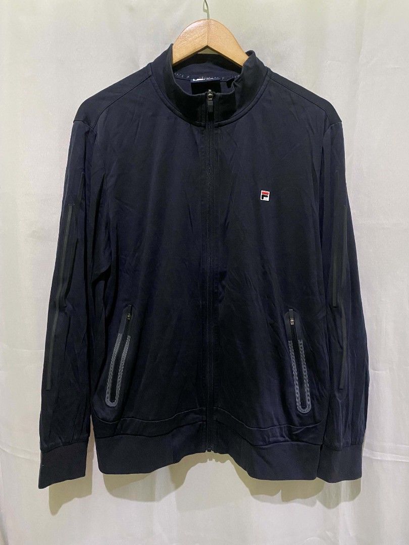 Fila White Line Heritage Navy Zip Jacket Size L (Category: Coats, Jackets and Outerwear) located in Quezon City. Submitted by elihur.tuazon (Listing ID 1465479360, Image 1). Description: - Brand/Line: Fila White Line Heritage - Style: Navy zip-up jacket with stand-up collar - Size: L (175/96A) - Features: Full zip front, dual zippered front pockets with ribbed trim, subtle tonal sleeve stripes - Condition/Vibe: Clean look, soft fabric, easy every