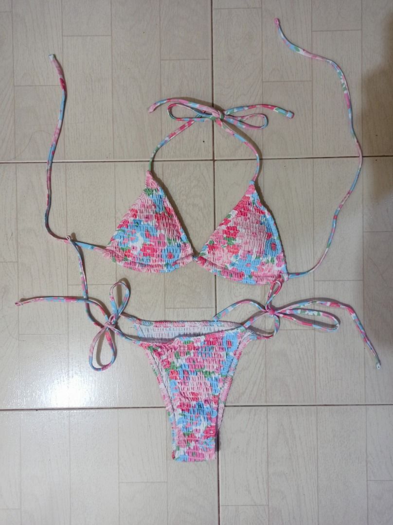 Floral Smocked Bikini Set (Category: Bikinis & Swimsuits) located in Legazpi City. Submitted by swimmingle61775 (Listing ID 1465498859, Image 1). Description: Never been used 😞 Napaka impulsive kong binili, ending di naman nagamit. 📍 Mandaluyong City 🍭Description: - Style: Smocked bikini set with a vibrant floral pattern (pink, blue, and green) - Top: Triangle halter neck with adjustable back and neck ties, can change pads - Bottoms: Adjustabl