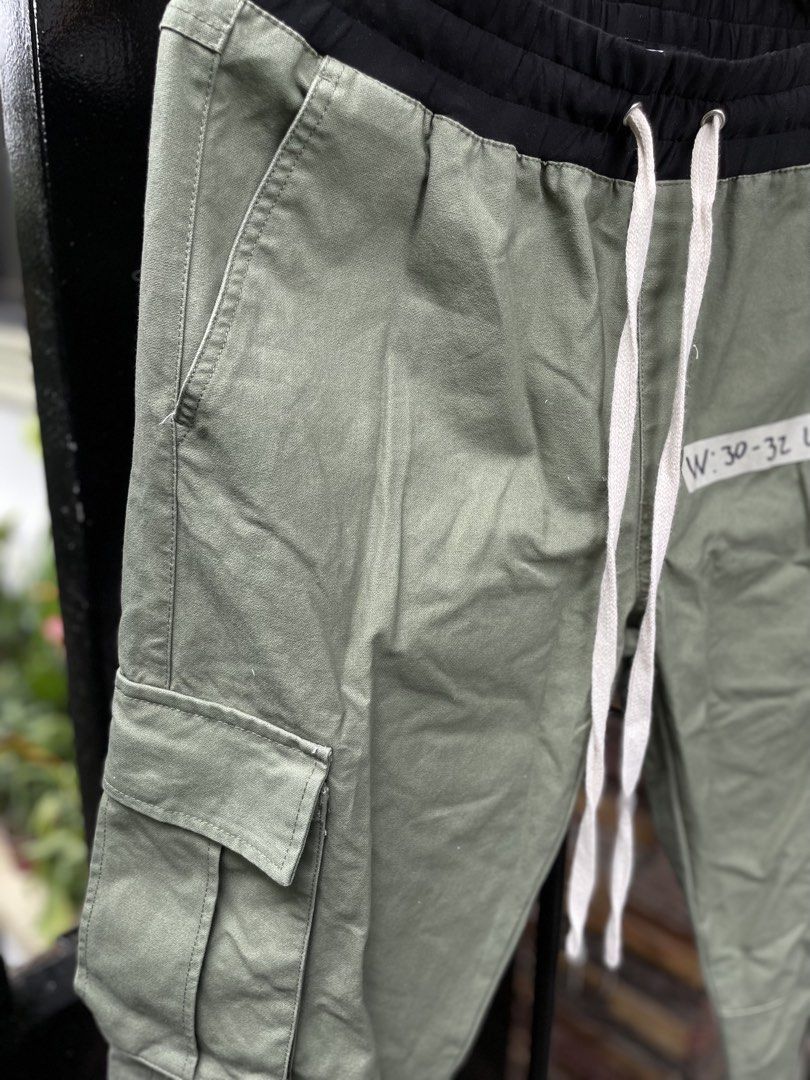 Forever 21 Green Cargo Pants with Zippers (Category: Chinos) located in Baguio. Submitted by jomelcavit29012 (Listing ID 1465551701, Image 2). Description: Forever 21 Green Cargo Pants with Zippers - Condition : 10/10 - Color way : Light Green - Green cargo pants from Forever 21. -Contrast black elastic waistband with adjustable white drawstring featuring metal tips. - Utility pockets on both sides and back. - - Ankle zippers on the cuffs for adj