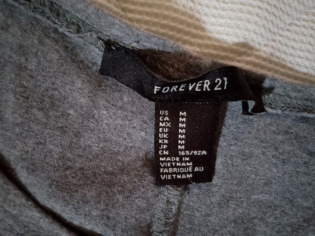 Forever 21 Grey Tank Dress (Category: Dresses) located in Aroroy. Submitted by itsyviii (Listing ID 1465534397, Image 3). Description: - Brand: Forever 21 - Item: Grey skater dress - Size: Medium - Style: Tank top style, scooped neckline, sleeveless, fitted bodice, and flared skirt - Material: Soft, stretchy jersey fabric - Condition: Good basic piece - Versatility: Perfect for casual daily wear, easy to dress up with a jacket or sneakers.