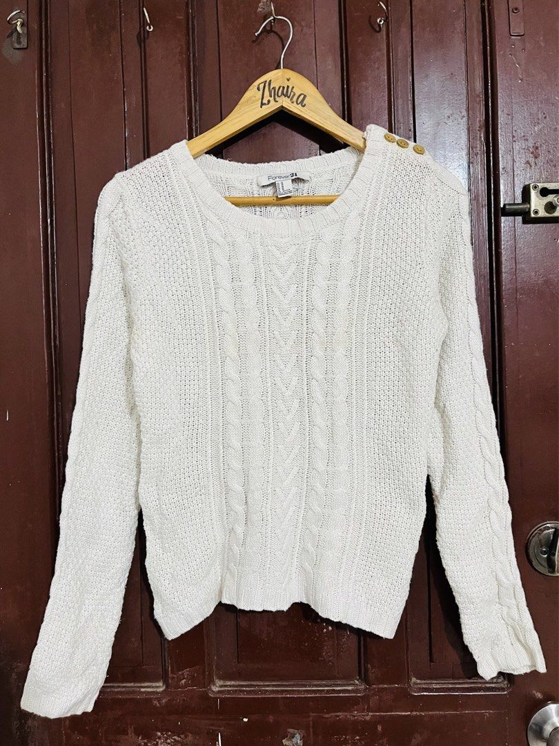 Forever 21 White Cable Knit Wool-blend Sweater Size M (Category: Longsleeves) located in Pagsanjan. Submitted by zhairaaaaa (Listing ID 1465512823, Image 3). Description: FOREVER 21 COZY WHITE CABLE-KNIT SWEATER 🤍 🔥 SALE! 400 PESOS ONLY! 🔥 Verygood condition 💯 ✨ Classic cable-knit texture ✨ Cozy crewneck design ✨ Distinctive decorative button details along the left shoulder ✨ Clean white shade — easy to style ✨ Perfect for chilly days and eve