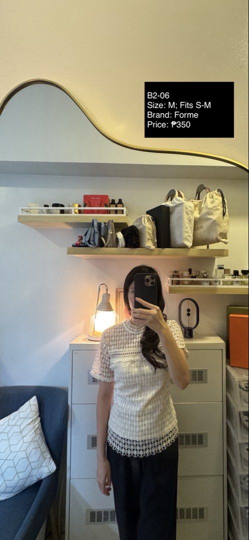 Forme White Lace Short Sleeve Top (Category: Blouses) located in Makati City. Submitted by thrift.plethora (Listing ID 1465460826, Image 1). Description: - Brand: Forme - Color: White - Size: Medium (fits Small to Medium frames) - Design: Intricate laser-cut lace pattern, high neckline with mock collar, and scalloped hem - Styling: Versatile piece, perfect for both casual days and dressy occasions, easy to pair with pants or skirts.