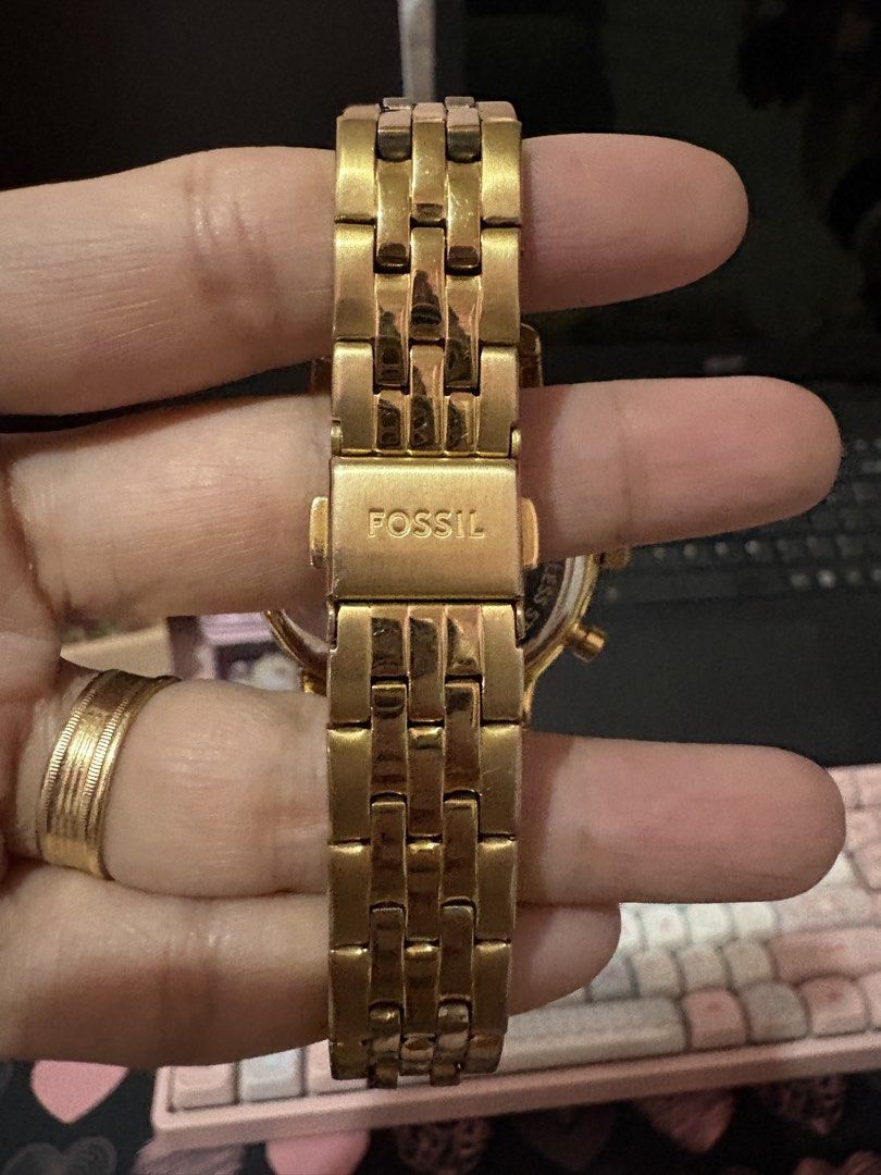 Fossil Gold Chronograph Watch With stones (Category: Women's Watches) located in Quezon City. Submitted by tonijoydeus (Listing ID 1465467857, Image 2). Description: - Brand: Fossil - Color: Gold-tone / quartz - Dial: Mother-of-pearl with chronograph subdials & date window at 4 o'clock - Bezel: Sparkling crystal-embellished bezel - Strap: Metal link bracelet with folding clasp - Inclusions: Original yellow plaid tin case and paperwork - Condition