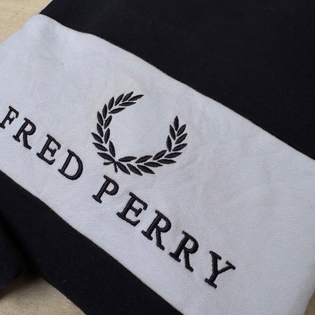 Fred Perry Black and White Sweatshirt Size M (Category: Coats, Jackets and Outerwear) located in Tagum. Submitted by johntams_ (Listing ID 1465481258, Image 2). Description: - Brand: Fred Perry - Item: Crewneck Sweatshirt - Color: Black with wide white chest stripe - Size: Medium - Design: Large embroidered laurel wreath logo and lettering on front - Material: Soft cotton blend - Features: Ribbed cuffs and hem, great for layering - Condition: Bra
