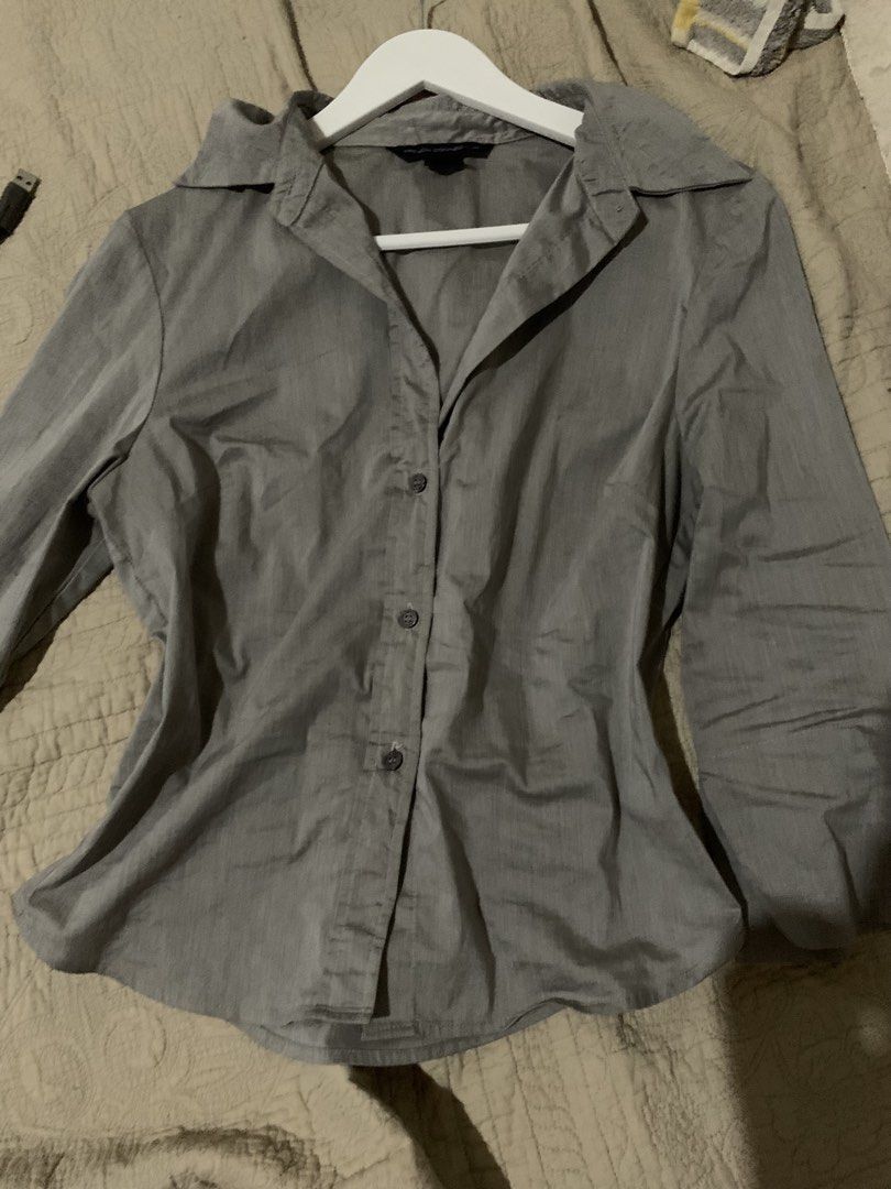 French Connection Grey Button-Up Collared Blouse Shirt (Category: Blouses) located in Manila. Submitted by spaceshop12345 (Listing ID 1465474475, Image 1). Description: - Brand: French Connection - Color: Classic Grey - Fit: Fitted cut through the waist - Features: Long sleeves, structured collar, dark front buttons - Style: Corporate / Smart Casual - Versatility: Easy to match with trousers or skirts - Condition: Great pre-loved condition.