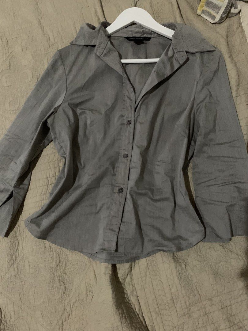French Connection Grey Button-Up Collared Blouse Shirt (Category: Blouses) located in Manila. Submitted by spaceshop12345 (Listing ID 1465474475, Image 3). Description: - Brand: French Connection - Color: Classic Grey - Fit: Fitted cut through the waist - Features: Long sleeves, structured collar, dark front buttons - Style: Corporate / Smart Casual - Versatility: Easy to match with trousers or skirts - Condition: Great pre-loved condition.