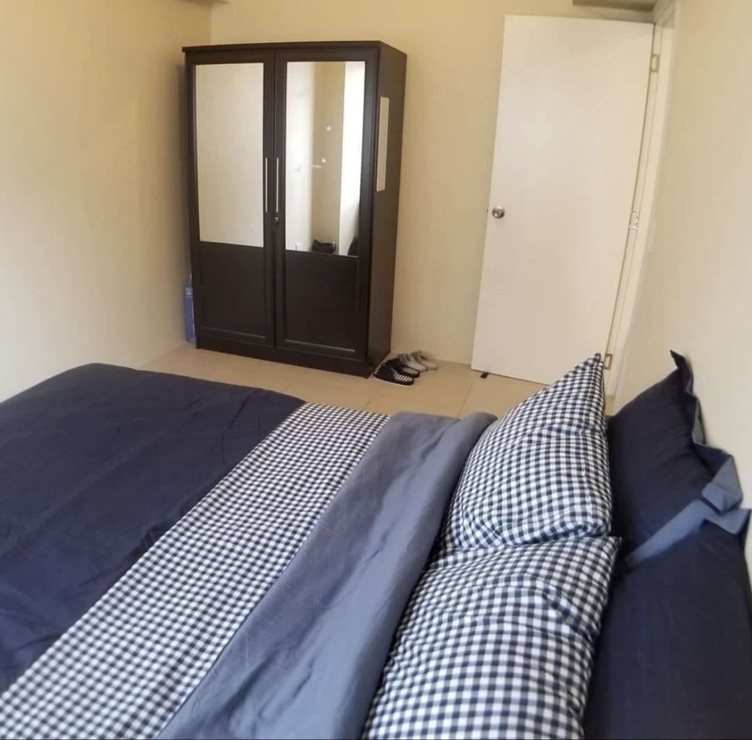 Fully Furnished Studio Condominium Unit With Complete Appliances (Category: Apartments & Condos) located in Bacoor. Submitted by honeybunsshoppe (Listing ID 1465438305, Image 3). Description: - Fully furnished studio layout, move-in ready - Sleeping area: Double bed with pillows & wardrobe closet with mirror doors - Living area: Sofabed, flat screen TV on media console - Dining area: Table with four chairs - Kitchen: Built-in cabinets, refrigerat