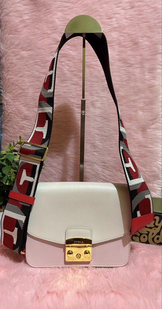 Furla Colorblock Leather Crossbody Bag with Patterned Strap (Category: Cross-body Bags) located in Tuguegarao City. Submitted by closet_jz (Listing ID 1465394021, Image 1). Description: - Brand: Furla - Material: Genuine leather in white and pink with red side panels - Hardware: Gold-tone - Closure: Signature front flap clasp - Strap: Wide, adjustable with a geometric red, white, black, and grey pattern - Condition: Clean interior, structured rec