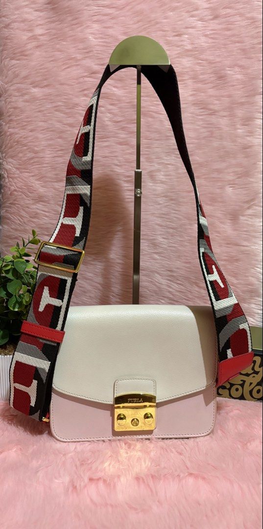 Furla Colorblock Leather Crossbody Bag with Patterned Strap (Category: Cross-body Bags) located in Tuguegarao City. Submitted by closet_jz (Listing ID 1465394021, Image 2). Description: - Brand: Furla - Material: Genuine leather in white and pink with red side panels - Hardware: Gold-tone - Closure: Signature front flap clasp - Strap: Wide, adjustable with a geometric red, white, black, and grey pattern - Condition: Clean interior, structured rec
