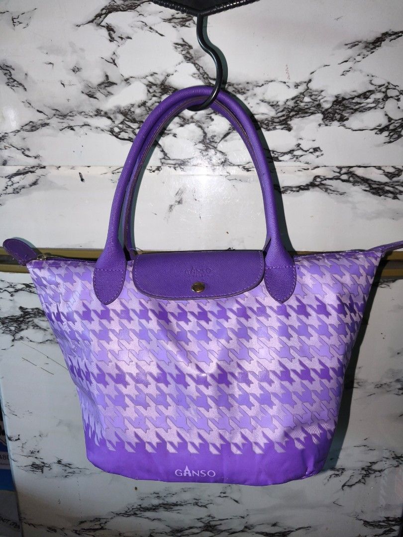 GANSO Purple Houndstooth Tote Bag Handbag (Category: Tote Bags) located in Cebu City. Submitted by raztadz (Listing ID 1465484271, Image 1). Description: - Brand: GANSO - Design: Eye-catching purple houndstooth pattern with solid purple leather-like handles - Closure: Front snap flap and secure top zipper with branded pull - Interior: Roomy and spacious for all your daily essentials - Condition: Excellent for everyday wear and standing out in sty