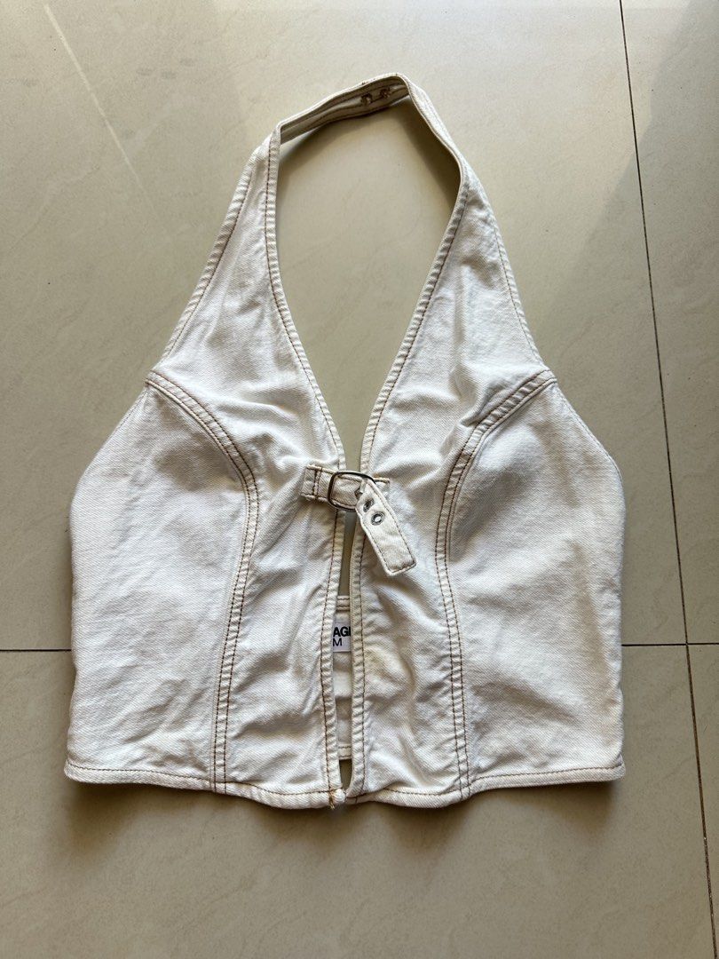 Garage halter denim top (Category: Sleeveless) located in Rosales. Submitted by dariang22 (Listing ID 1465406745, Image 3). Description: - Brand: I.AM.GIA - Style: White denim halter top with contrast brown stitching and open front cutout - Details: Front buckle closure - Size: M - Condition: Great structured piece - Styling: Perfect for warm weather, nights out, high-waisted jeans, or cargos.