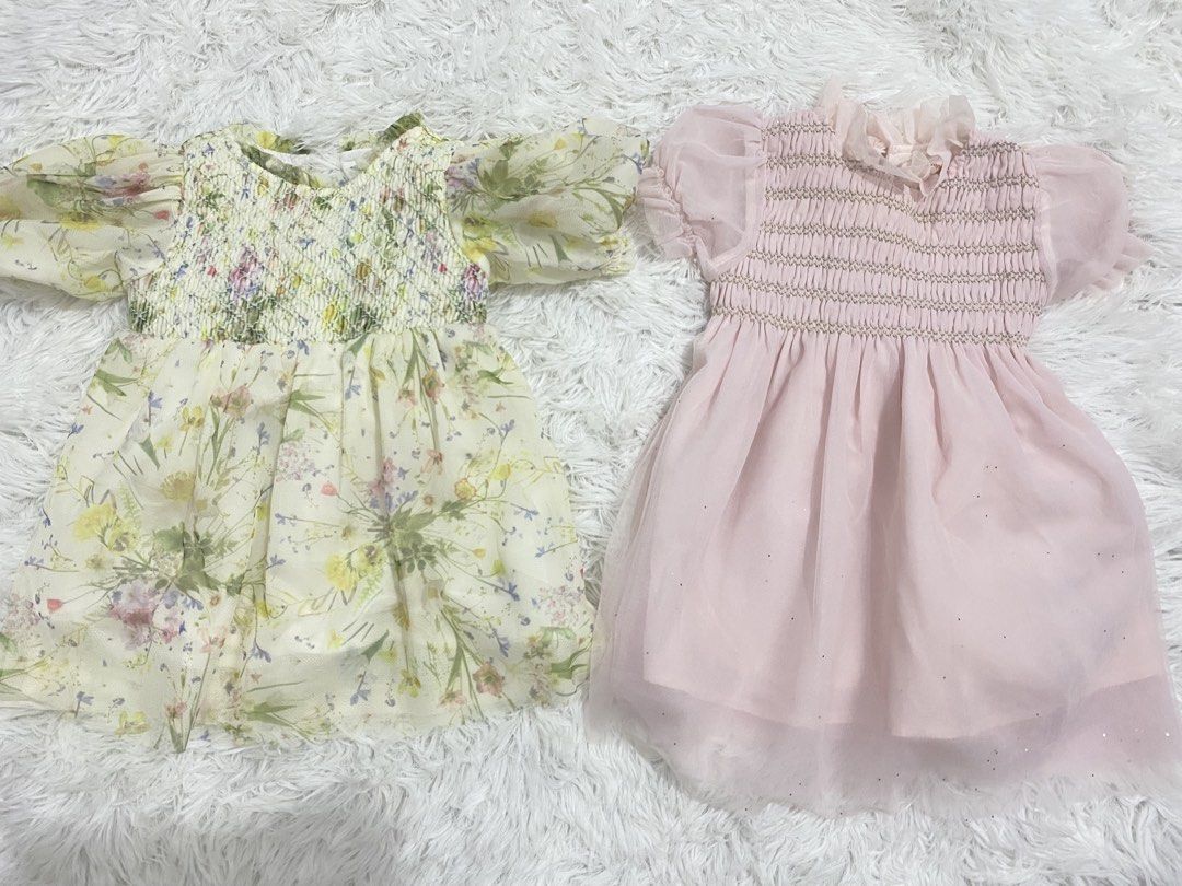Gingersnaps Dress Bundle Sale (Category: Babies & Kids Fashion) located in Pasig City. Submitted by jnnnngg (Listing ID 1465424817, Image 1). Description: - Set of 2 adorable baby dresses sold together - Dress 1: Soft yellow floral wildflower print with cute puff sleeves - Dress 2: Solid light pink with flutter sleeves and a sparkly glitter-dot tulle skirt - Comfort features: Stretchy smocked bodices and charming ruffle collars - Easy pull-on sty
