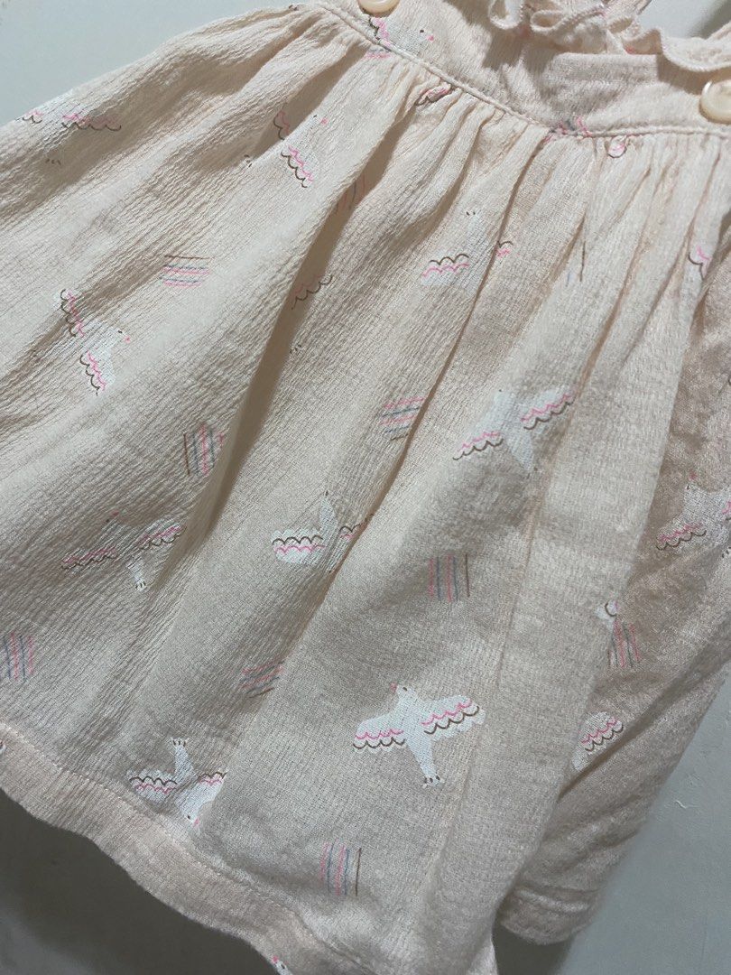 Gingersnaps jumper dress with bird pattern (Category: Babies & Kids Fashion) located in Las Pinas. Submitted by dhyn29 (Listing ID 1465529988, Image 2). Description: - Color/Design: Light pink with all-over bird and stripe print - Details: Criss-cross shoulder straps, ruffled neckline trim, and two front buttons - Fit/Style: Soft textured fabric, gathered waist, and flared skirt - Styling Tip: Easy to pair and layer with a onesie underneath - Con