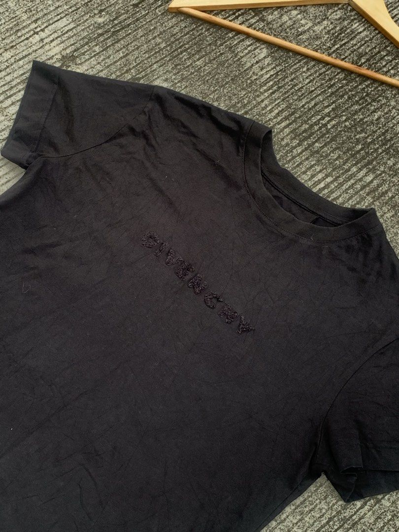 Givenchy Black Embroidered Logo T-Shirt (Category: Shirts) located in Manila. Submitted by boldphoenix.1aaaf1 (Listing ID 1465397939, Image 2). Description: - Brand: Givenchy - Color: Black - Material: Premium cotton - Fit: Regular fit with short sleeves - Design: Tone-on-tone embroidered Givenchy lettering on the front, large graphic circle print on the back - Condition: Clean, worn just a couple of times - Style: Great for streetwear and casual