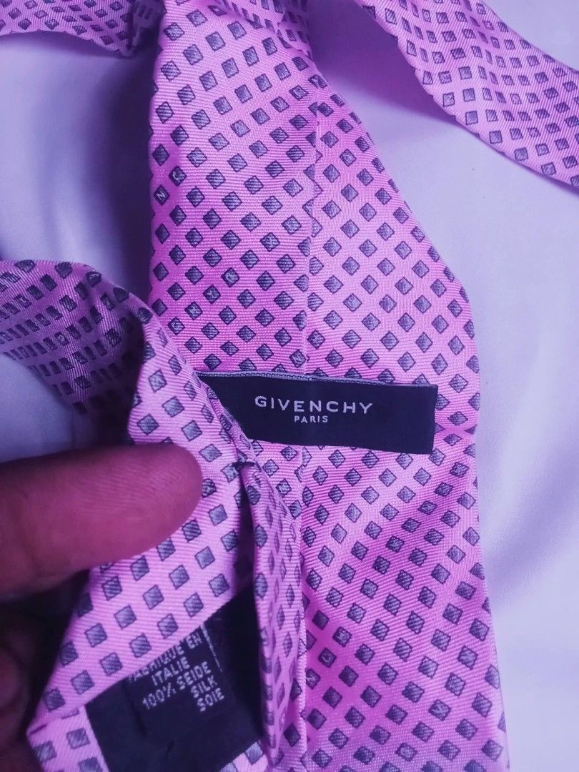 Givenchy Paris Pink Patterned Silk Tie (Category: Ties) located in Manila. Submitted by josephlim13 (Listing ID 1465552312, Image 3). Description: - Brand: Givenchy Paris - Material: 100% Pure Silk, Made in Italy - Color/Design: Bright pink with dark patterned diamond shapes - Style: Classic width neckwear - Condition: Excellent, with 'Dry Clean Only' tag attached - Ideal for: Formal events, weddings, or professional office wear.