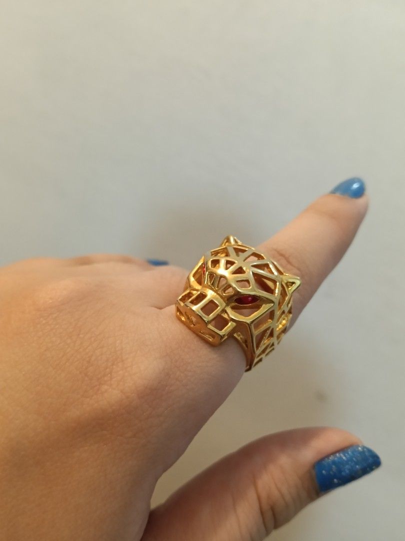 Gold Panther Ring with Red Gemstone Eyes (Category: Rings) located in Manila. Submitted by dearsunnystore (Listing ID 1465550397, Image 3). Description: - Statement ring featuring a striking panther head design - Luxurious gold-tone finish with a modern geometric cut-out pattern - Eye-catching bright red stones set securely into the eye sockets - Chunky style that adds a bold touch to any outfit - Perfect accessory to elevate your everyday or eve